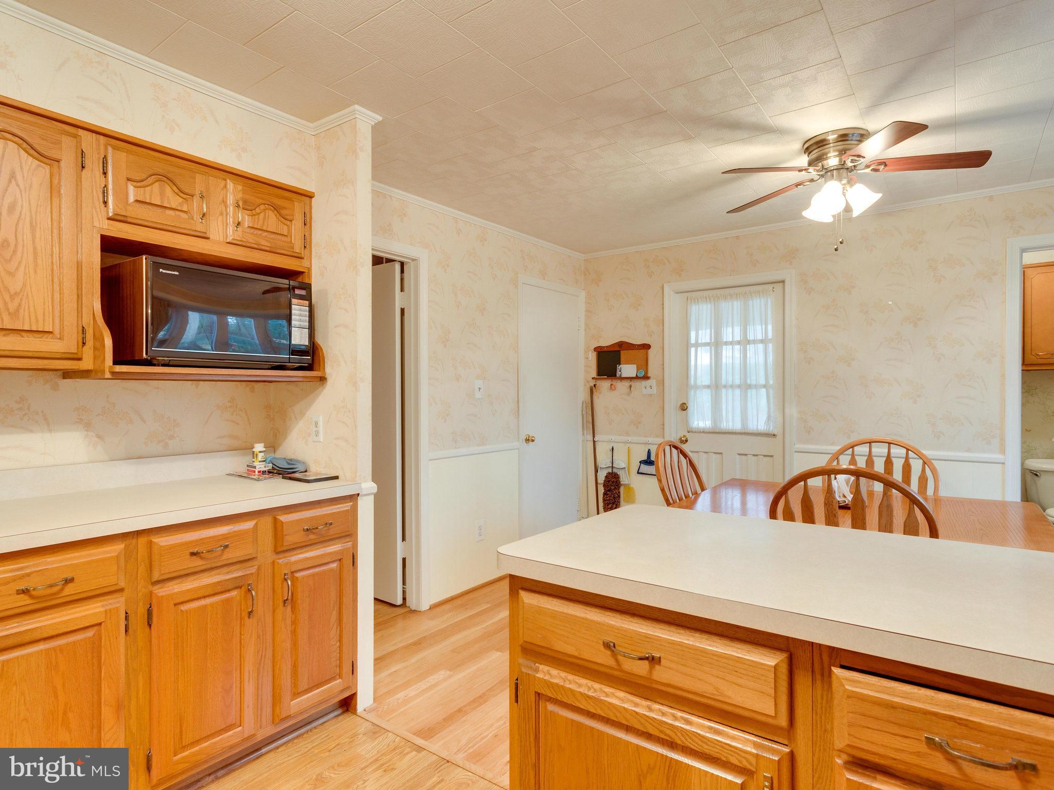 8613 Victoria Road Springfield, VA 22151 - Photo 4 of 21 a kitchen with stainless steel appliances kitchen island granite countertop a sink and cabinets