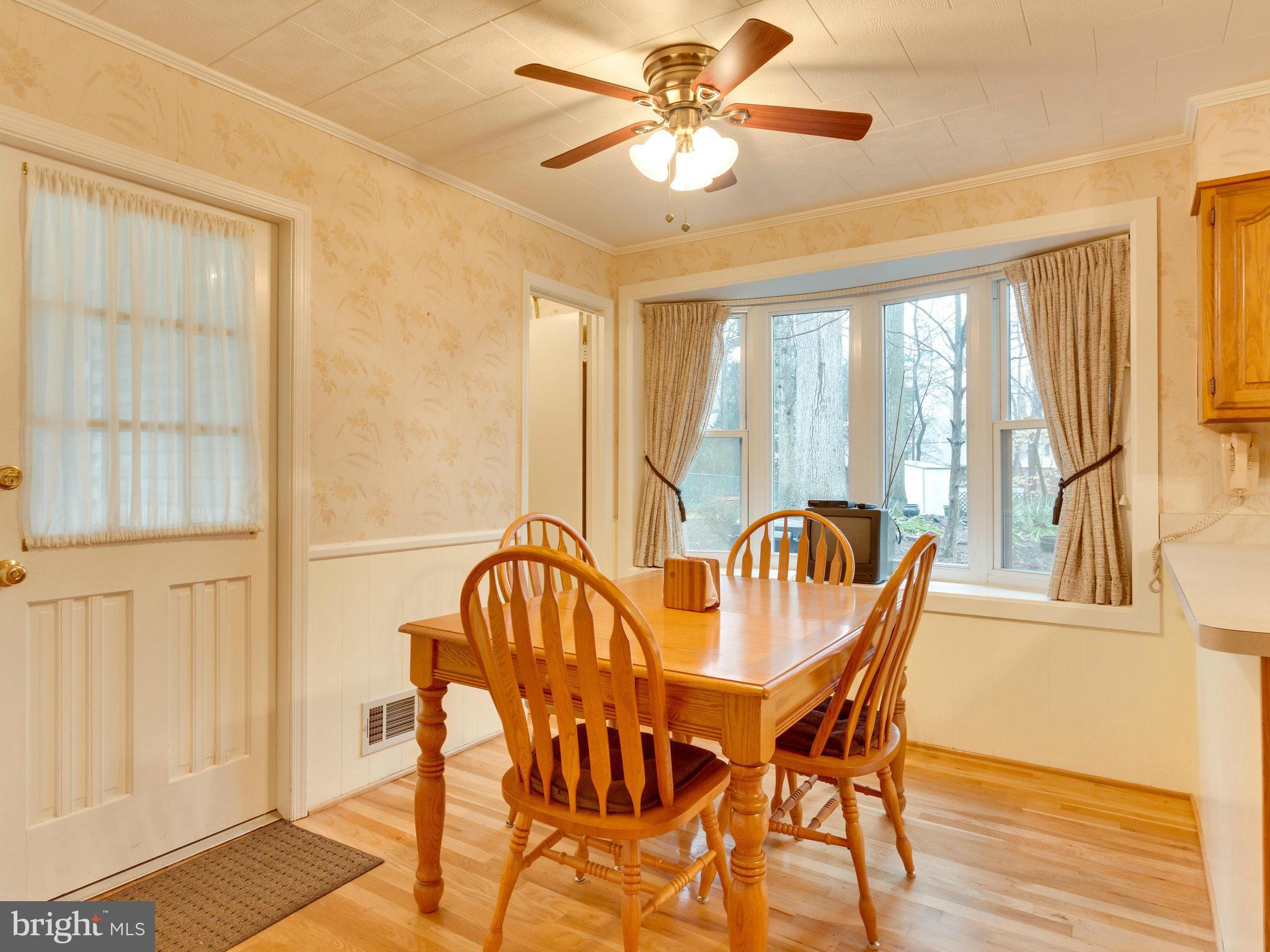 8613 Victoria Road Springfield, VA 22151 - Photo 5 of 21 a view of a dining room with furniture window and wooden floor