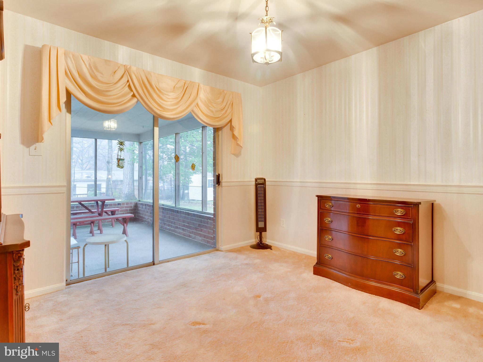8613 Victoria Road Springfield, VA 22151 - Photo 8 of 21 a view of a room with wooden floor and cabinet