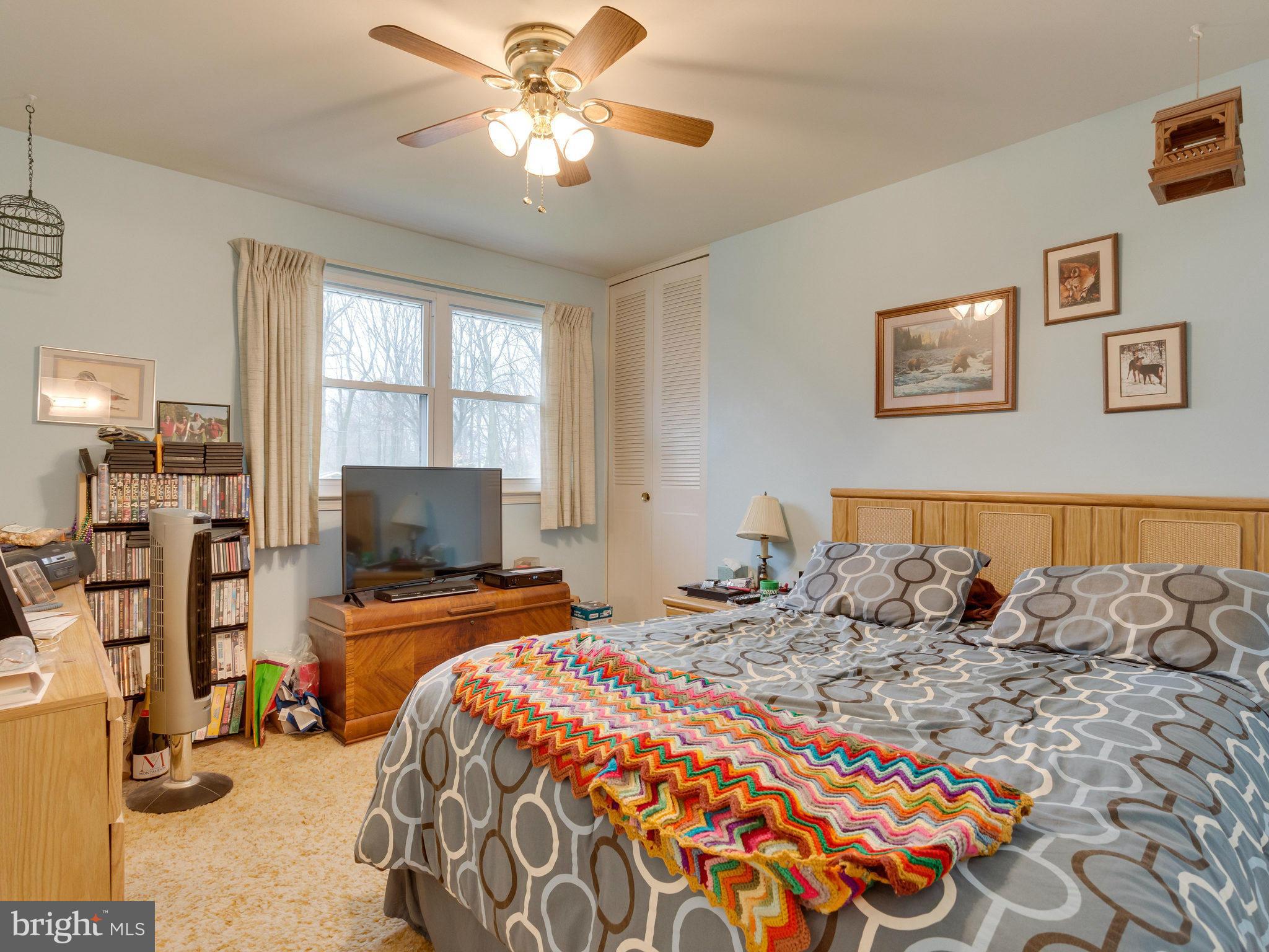8613 Victoria Road Springfield, VA 22151 - Photo 9 of 21 a bedroom with a bed and a flat screen tv