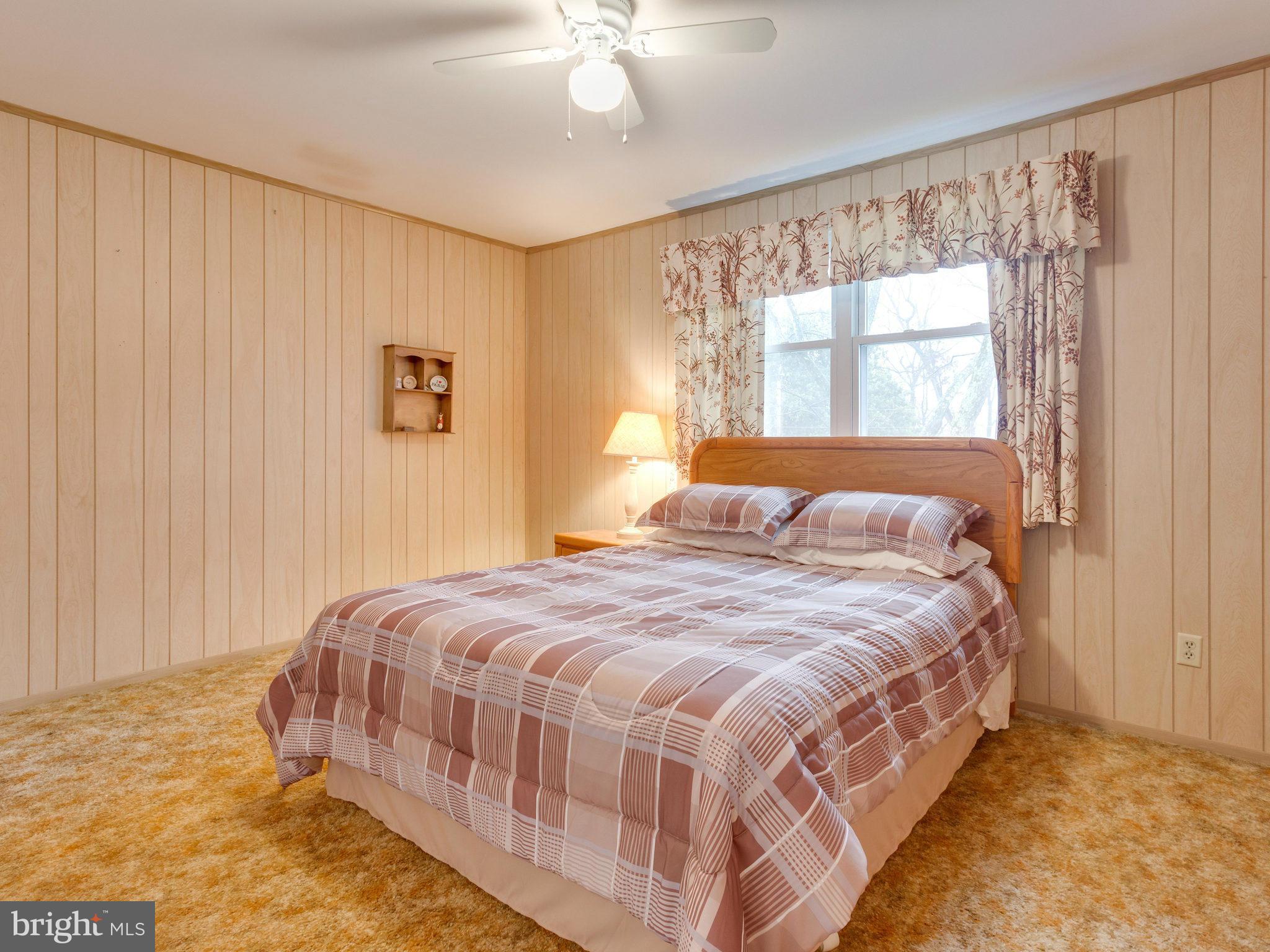 8613 Victoria Road Springfield, VA 22151 - Photo 10 of 21 a bedroom with a bed and window