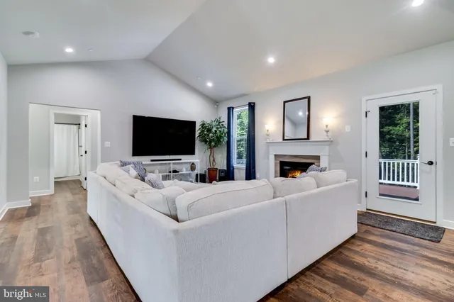 a kitchen with stainless steel appliances kitchen island granite countertop a sink stove and refrigerator