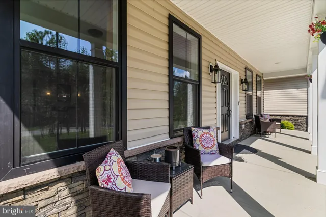 a view of a livingroom with furniture window and wooden floor