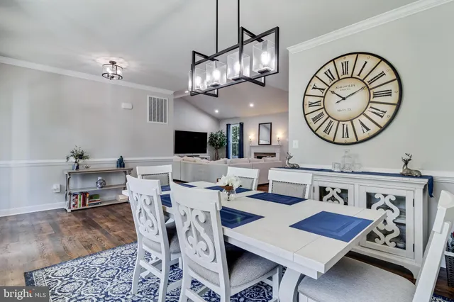 a living room with furniture fireplace and potted plant