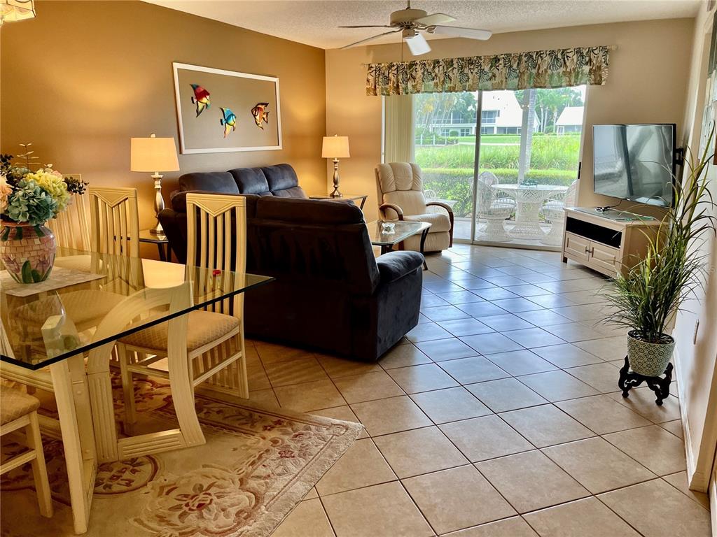 6503 Stone River Road, Unit 109 Bradenton, FL 34203 - Photo 14 of 65 a living room with furniture and a flat screen tv