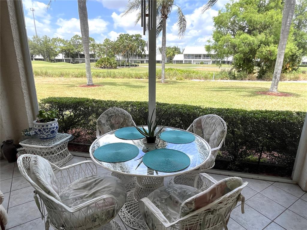 6503 Stone River Road, Unit 109 Bradenton, FL 34203 - Photo 2 of 65 a view of a patio with lawn chairs next to a yard