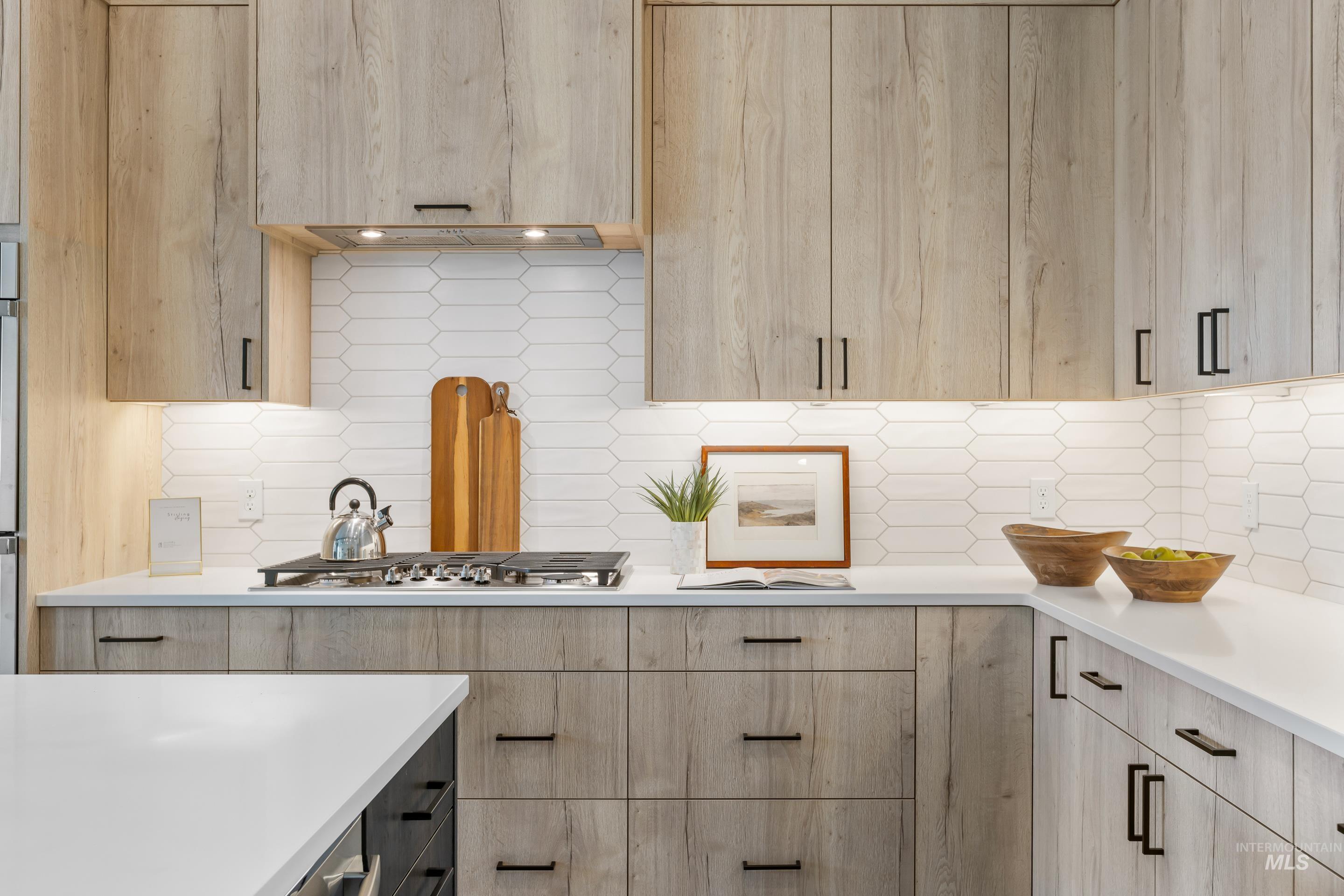 13 Blk 7 E Strut Way Boise, ID 83716 - Photo 17 of 50 Kitchen with light brown cabinets, decorative backsplash, modern cabinets, and light stone counters