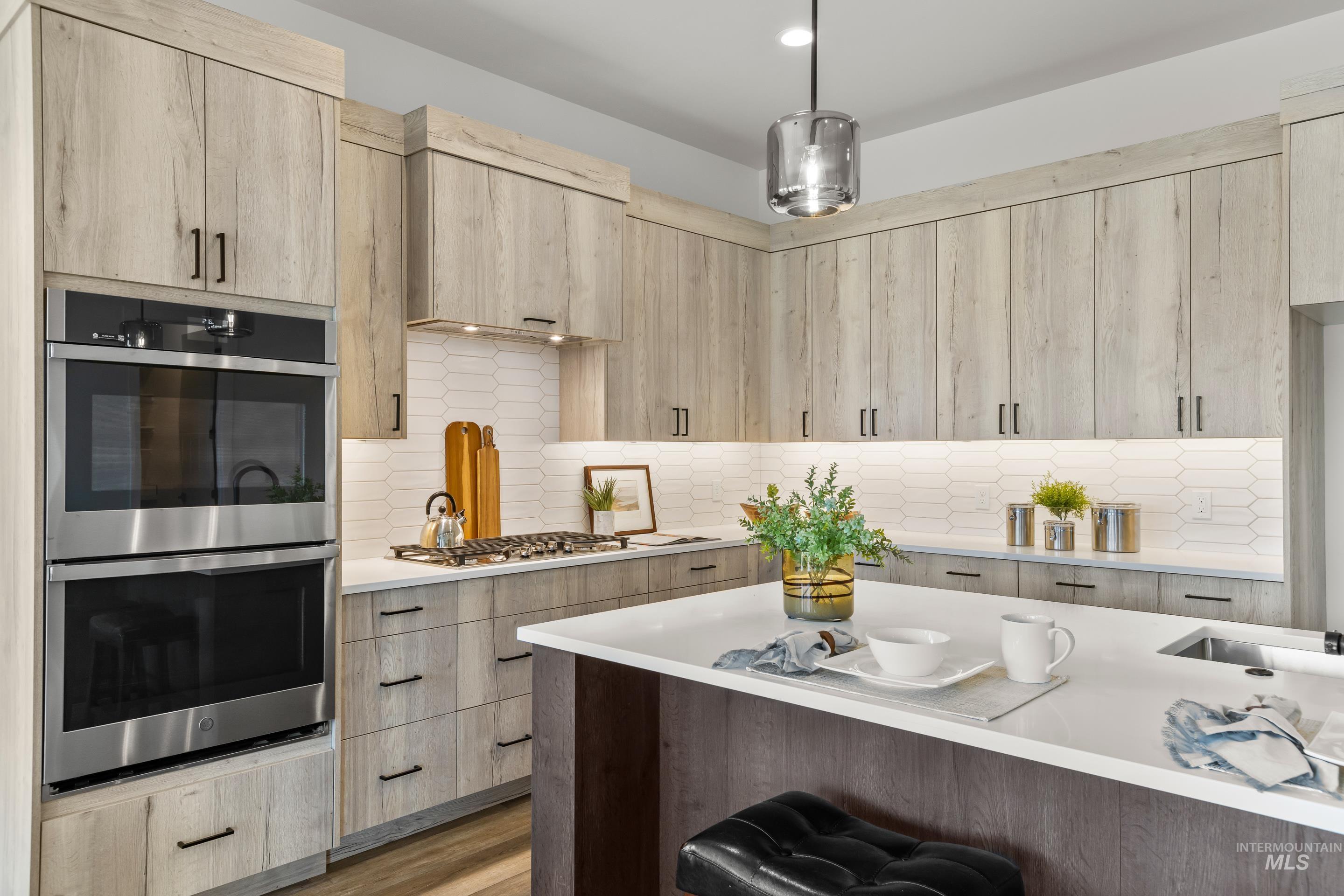13 Blk 7 E Strut Way Boise, ID 83716 - Photo 18 of 50 Kitchen featuring light brown cabinets, appliances with stainless steel finishes, modern cabinets, light stone counters, and recessed lighting