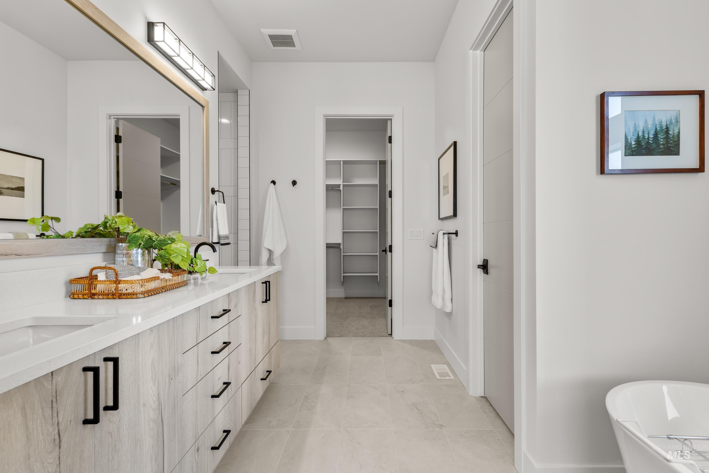 13 Blk 7 E Strut Way Boise, ID 83716 - Photo 27 of 50 Bathroom with a walk in closet, double vanity, a soaking tub, and light tile patterned flooring