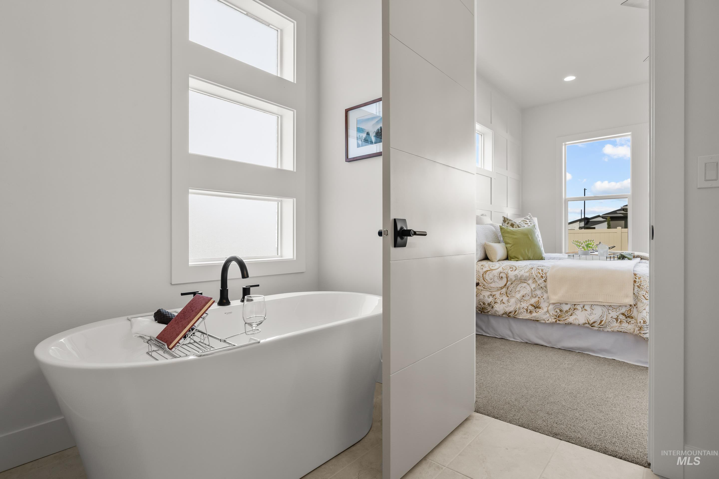 13 Blk 7 E Strut Way Boise, ID 83716 - Photo 32 of 50 Bathroom featuring connected bathroom, a freestanding tub, light carpet, and light tile patterned floors