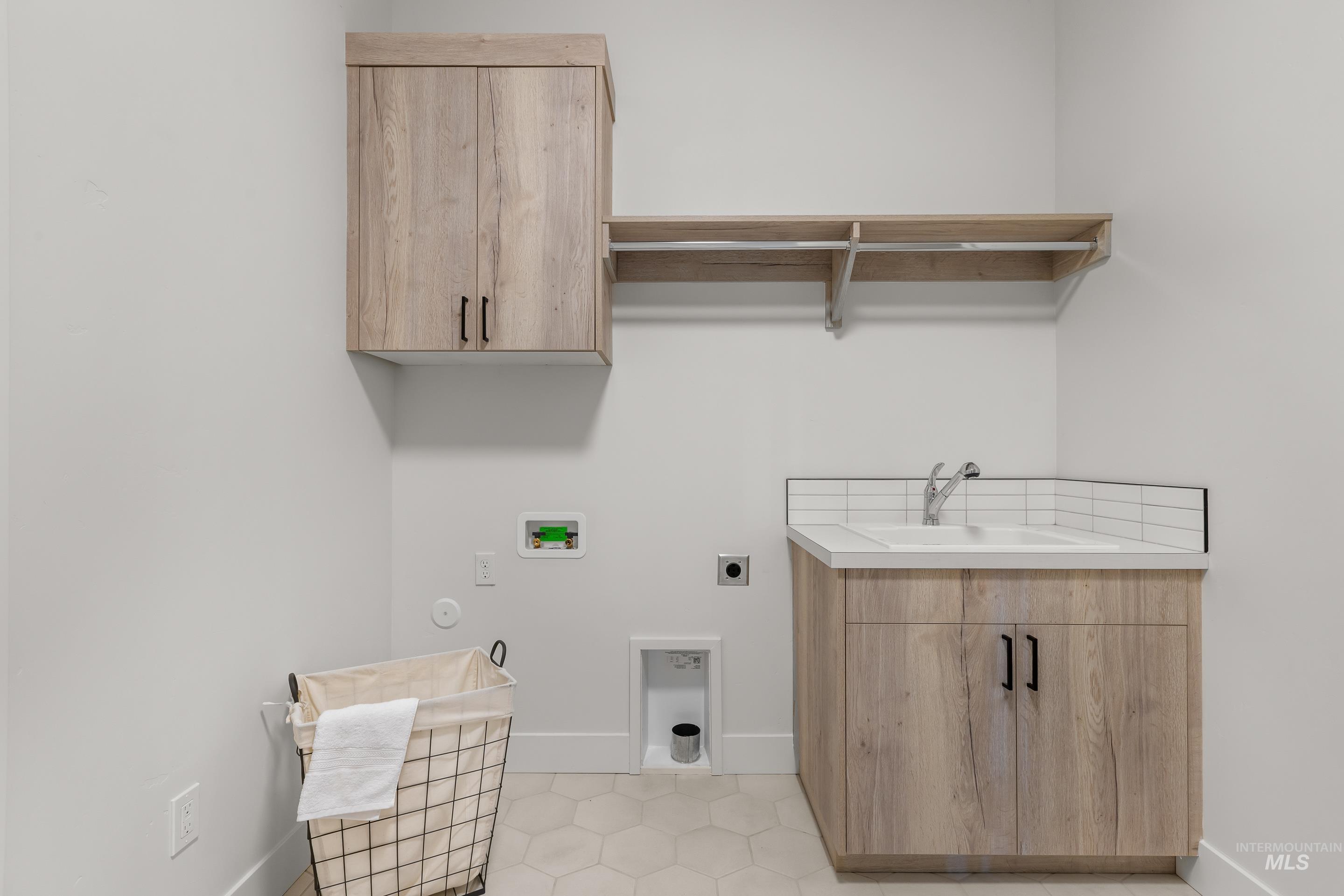 13 Blk 7 E Strut Way Boise, ID 83716 - Photo 37 of 50 Laundry room featuring cabinet space, hookup for a washing machine, electric dryer hookup, and light tile patterned floors