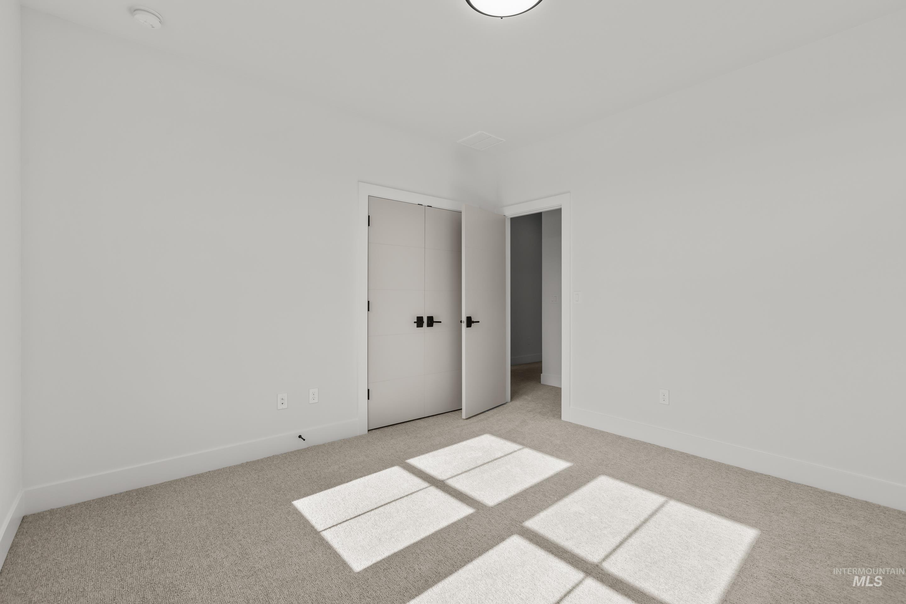 13 Blk 7 E Strut Way Boise, ID 83716 - Photo 40 of 50 Spare room with baseboards and light carpet