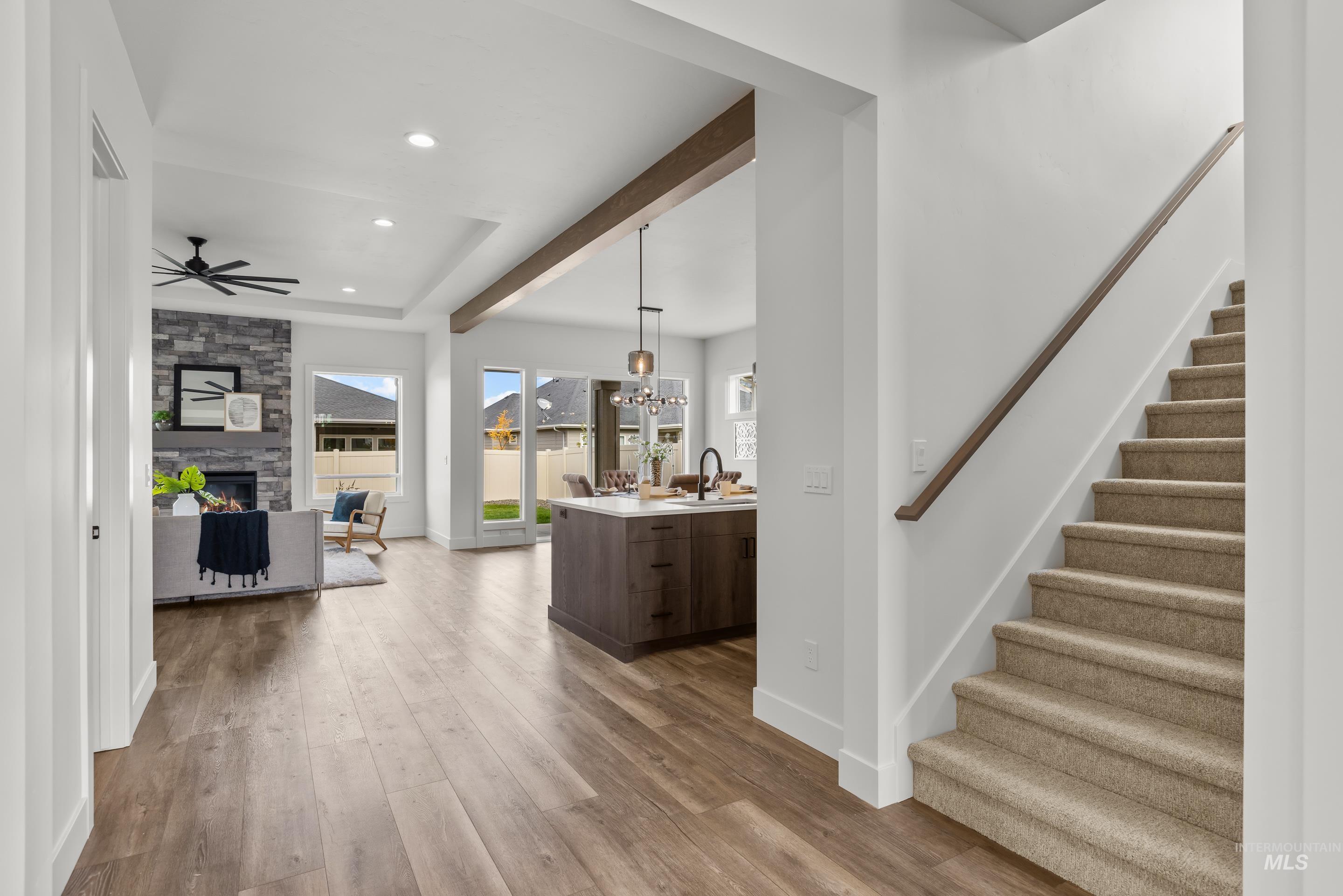 13 Blk 7 E Strut Way Boise, ID 83716 - Photo 4 of 50 Entrance foyer featuring stairway, light wood-type flooring, recessed lighting, a chandelier, and a stone fireplace