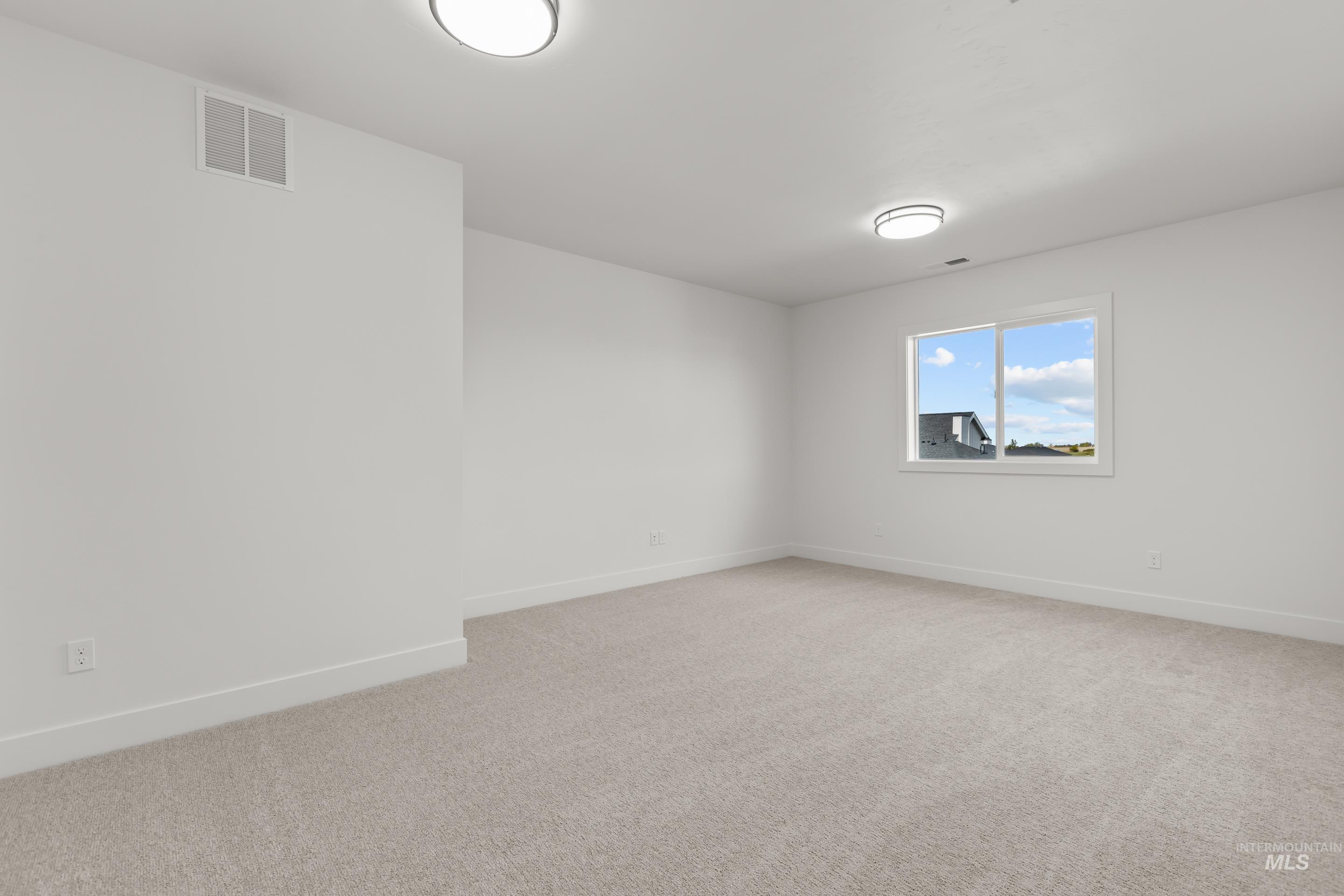 13 Blk 7 E Strut Way Boise, ID 83716 - Photo 44 of 50 Unfurnished room featuring light carpet and baseboards