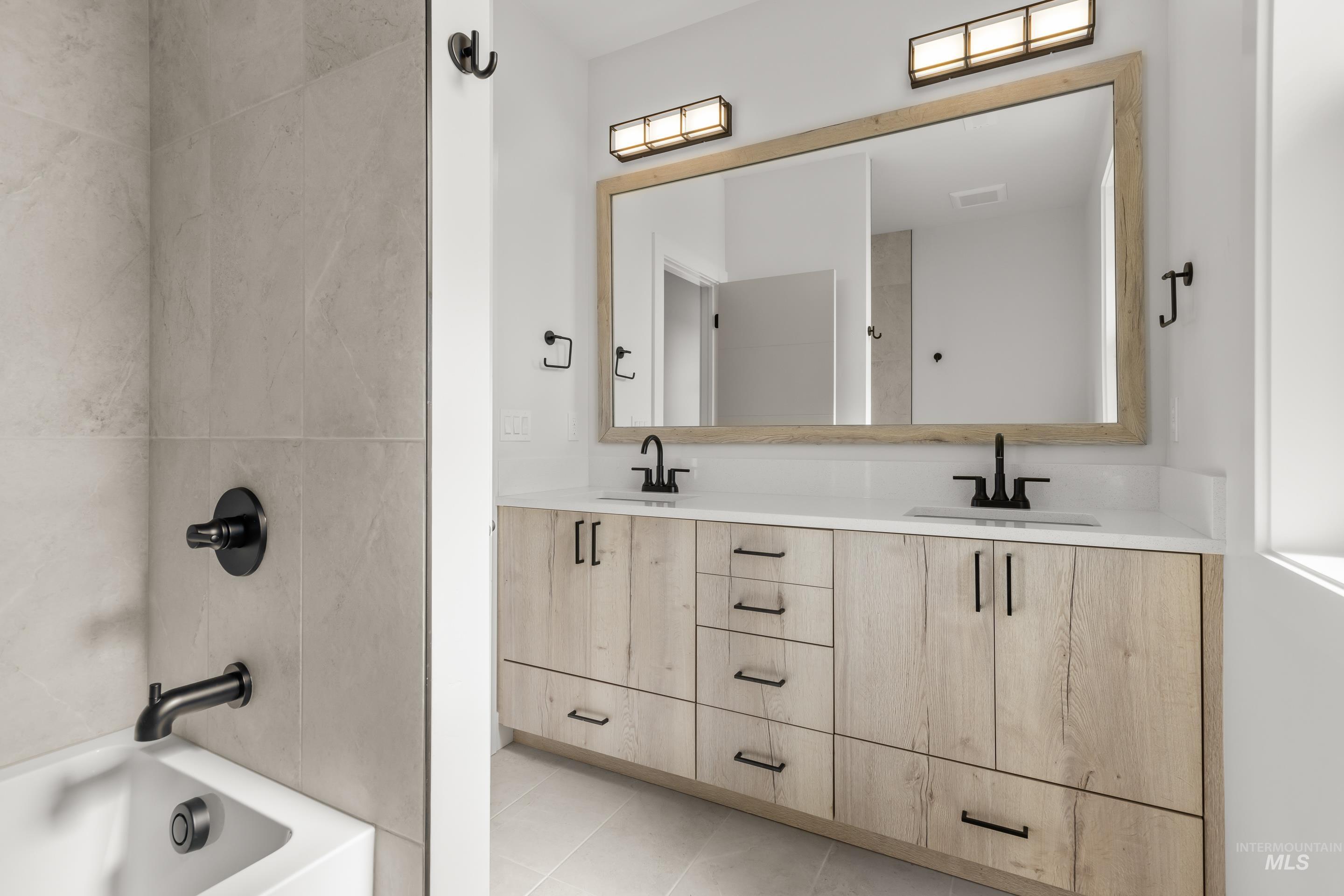 13 Blk 7 E Strut Way Boise, ID 83716 - Photo 47 of 50 Full bath with double vanity, shower / tub combination, and light tile patterned flooring