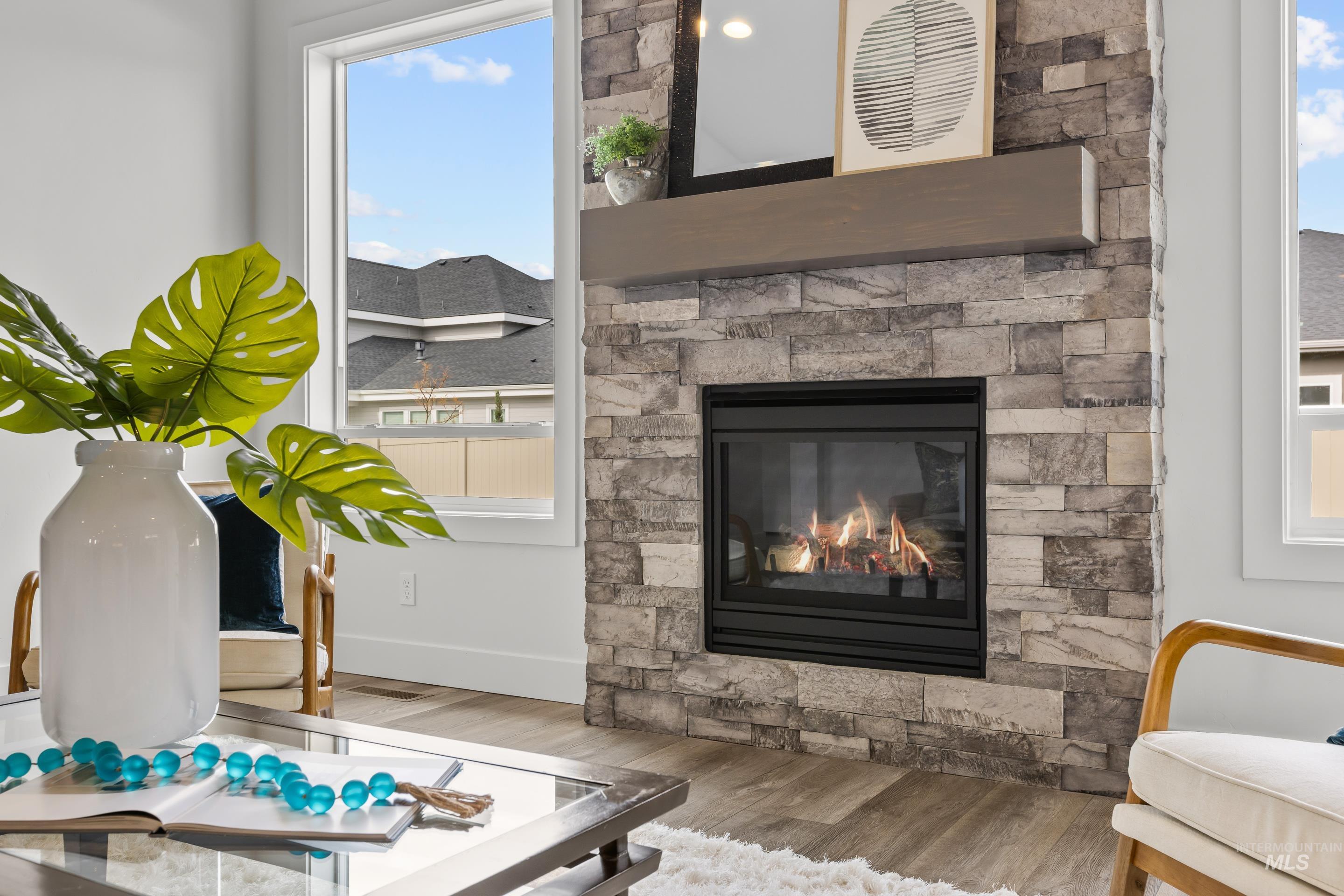 13 Blk 7 E Strut Way Boise, ID 83716 - Photo 8 of 50 Sitting room with wood finished floors and a stone fireplace