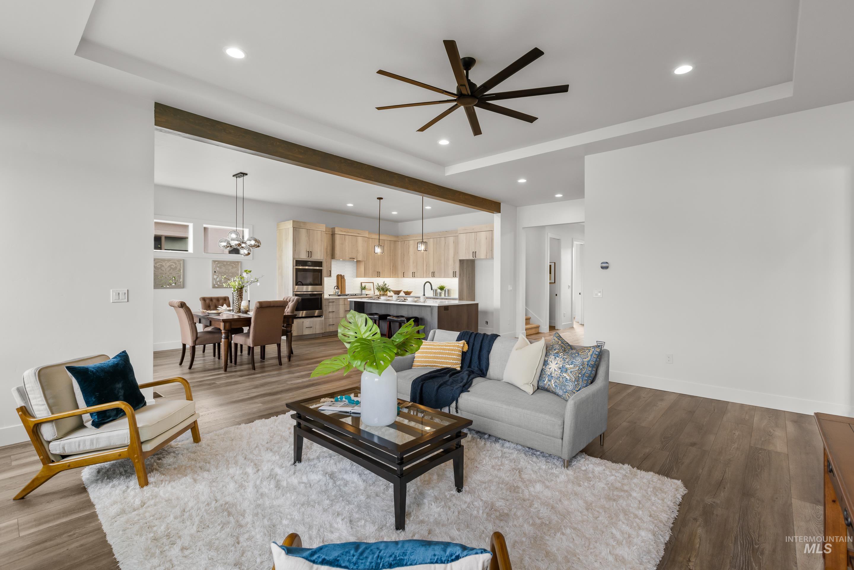 13 Blk 7 E Strut Way Boise, ID 83716 - Photo 9 of 50 Living area with dark wood-type flooring, ceiling fan, recessed lighting, a tray ceiling, and beamed ceiling