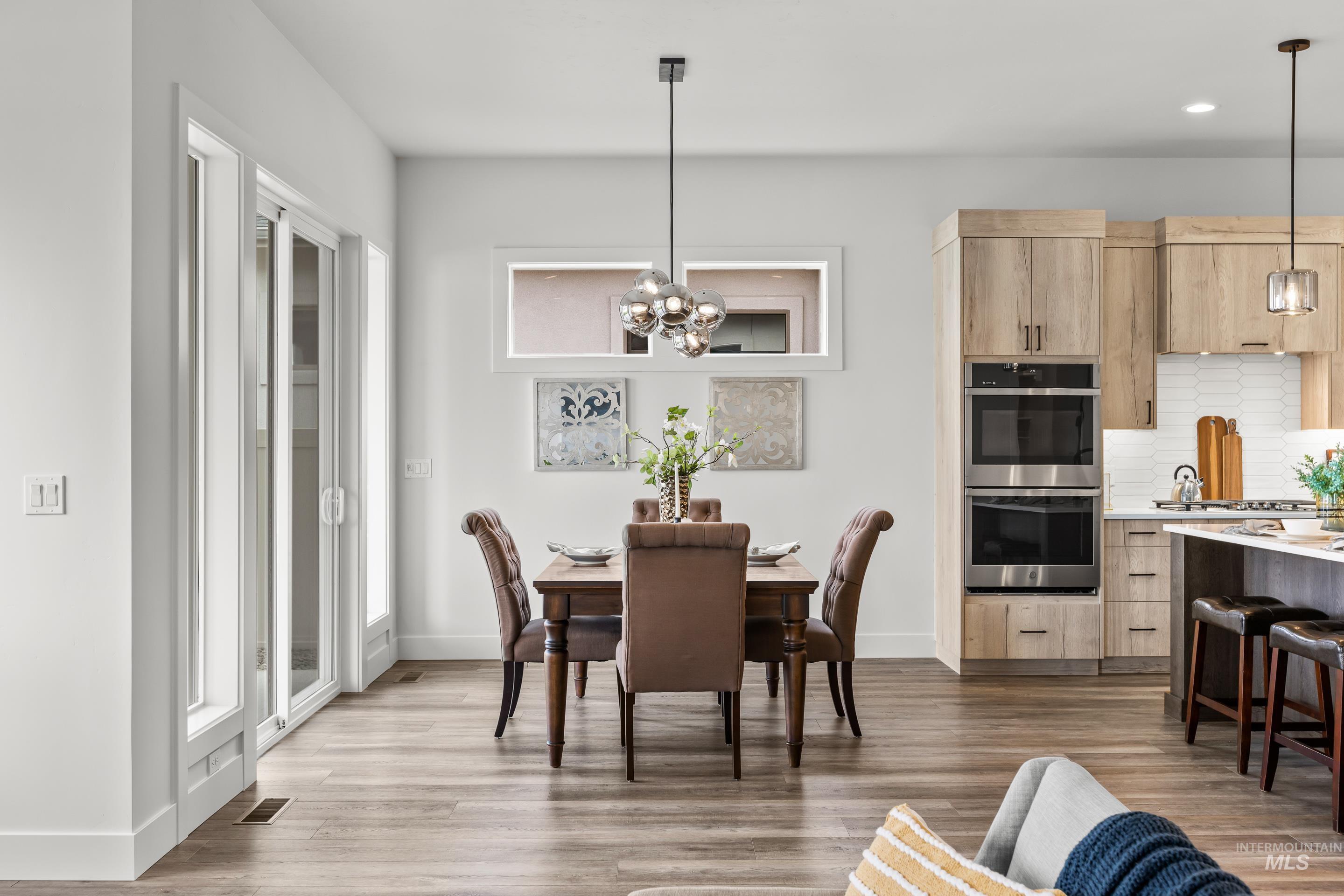 13 Blk 7 E Strut Way Boise, ID 83716 - Photo 10 of 50 Dining area featuring a chandelier, dark wood-style flooring, and recessed lighting