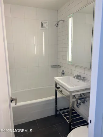 a bathroom with a sink a bathtub and a shower