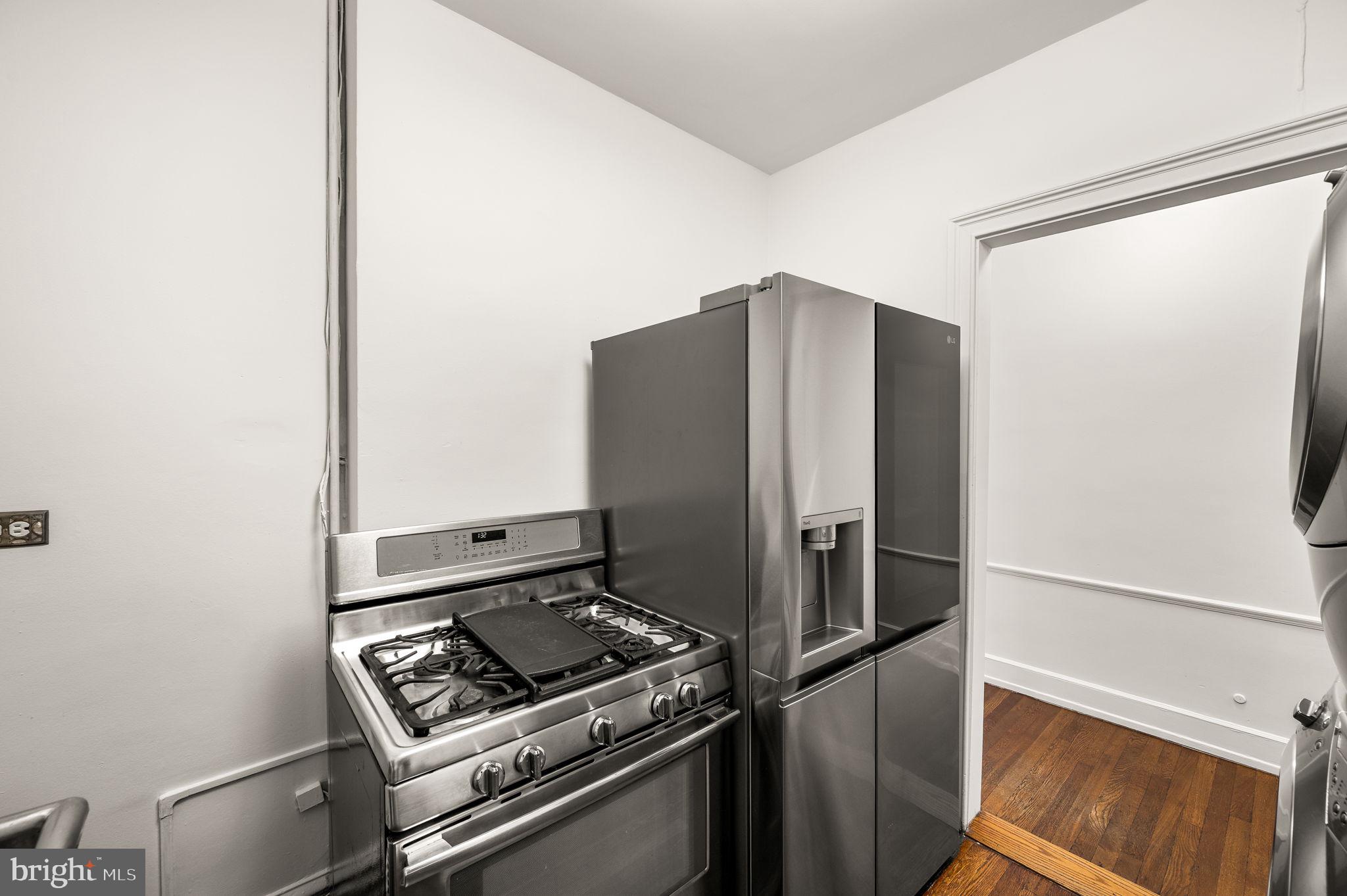1901 Walnut Street, Unit 20B Philadelphia, PA 19103 - Photo 13 of 24 a metallic refrigerator freezer sitting in a kitchen