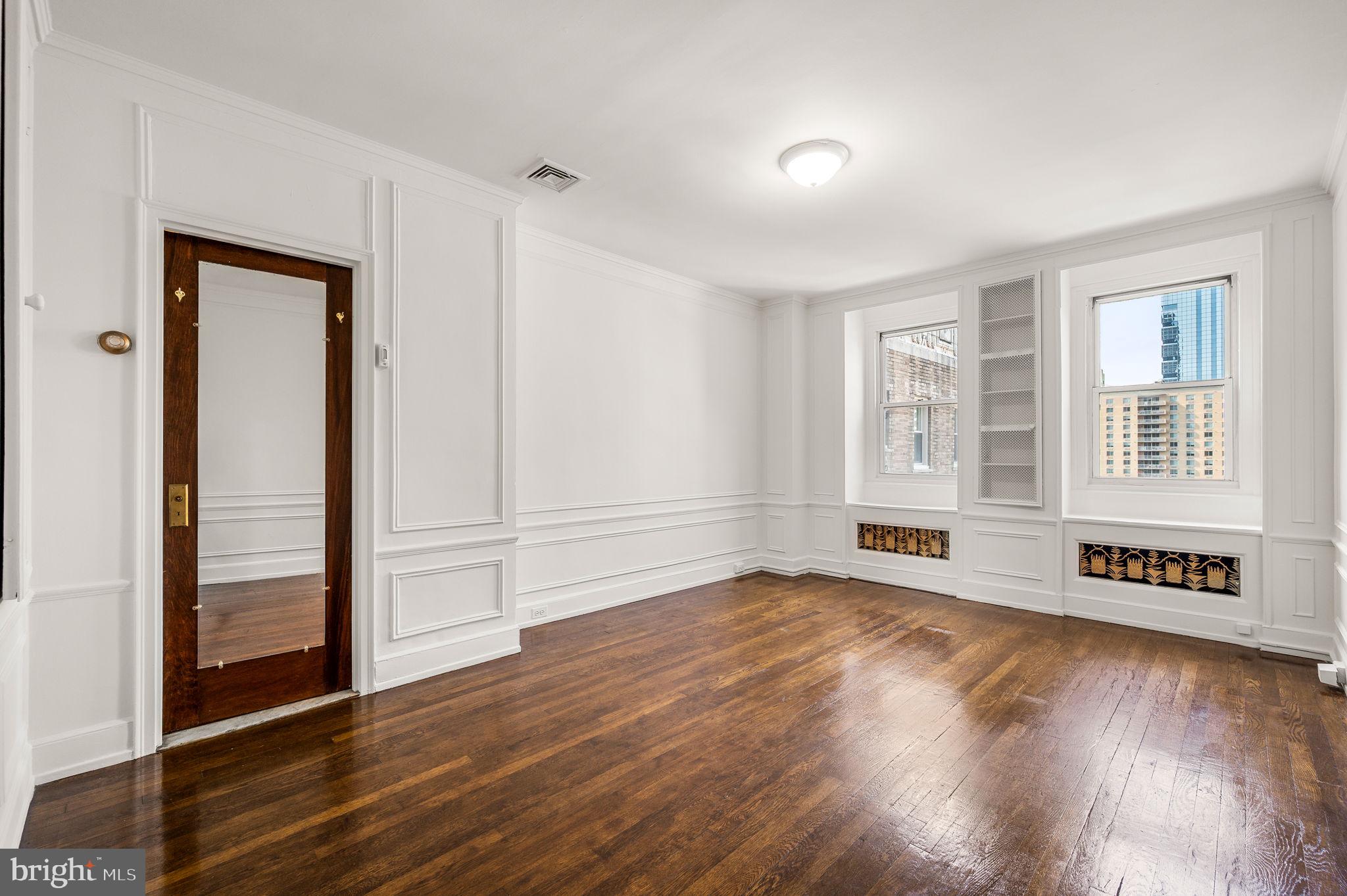 1901 Walnut Street, Unit 20B Philadelphia, PA 19103 - Photo 14 of 24 wooden floor in an empty room with a window
