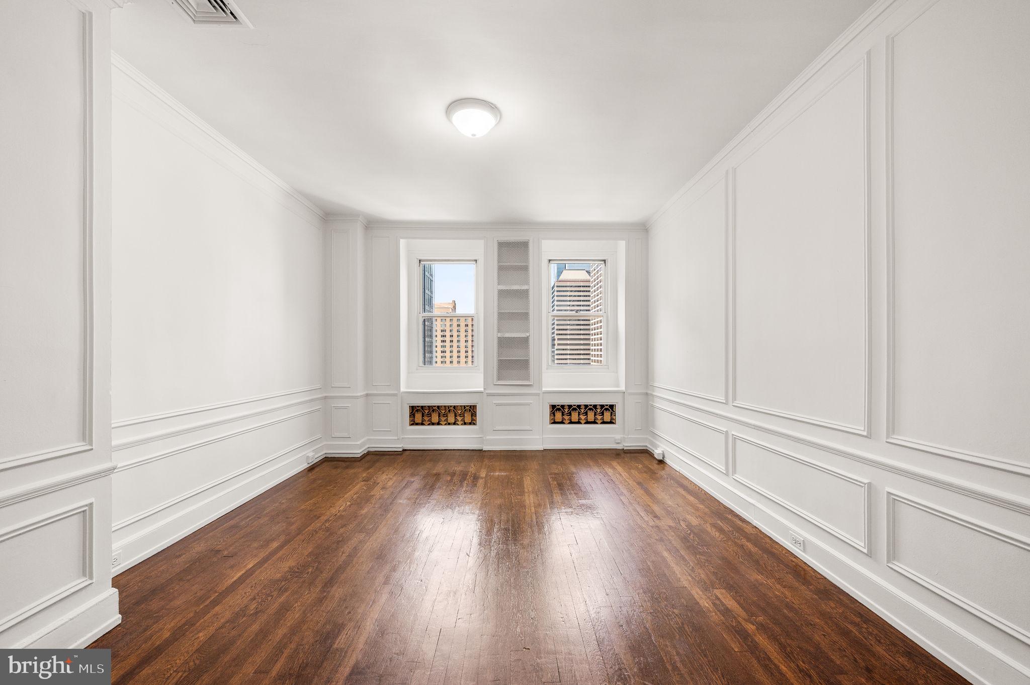 1901 Walnut Street, Unit 20B Philadelphia, PA 19103 - Photo 15 of 24 an empty room with wooden floor and windows