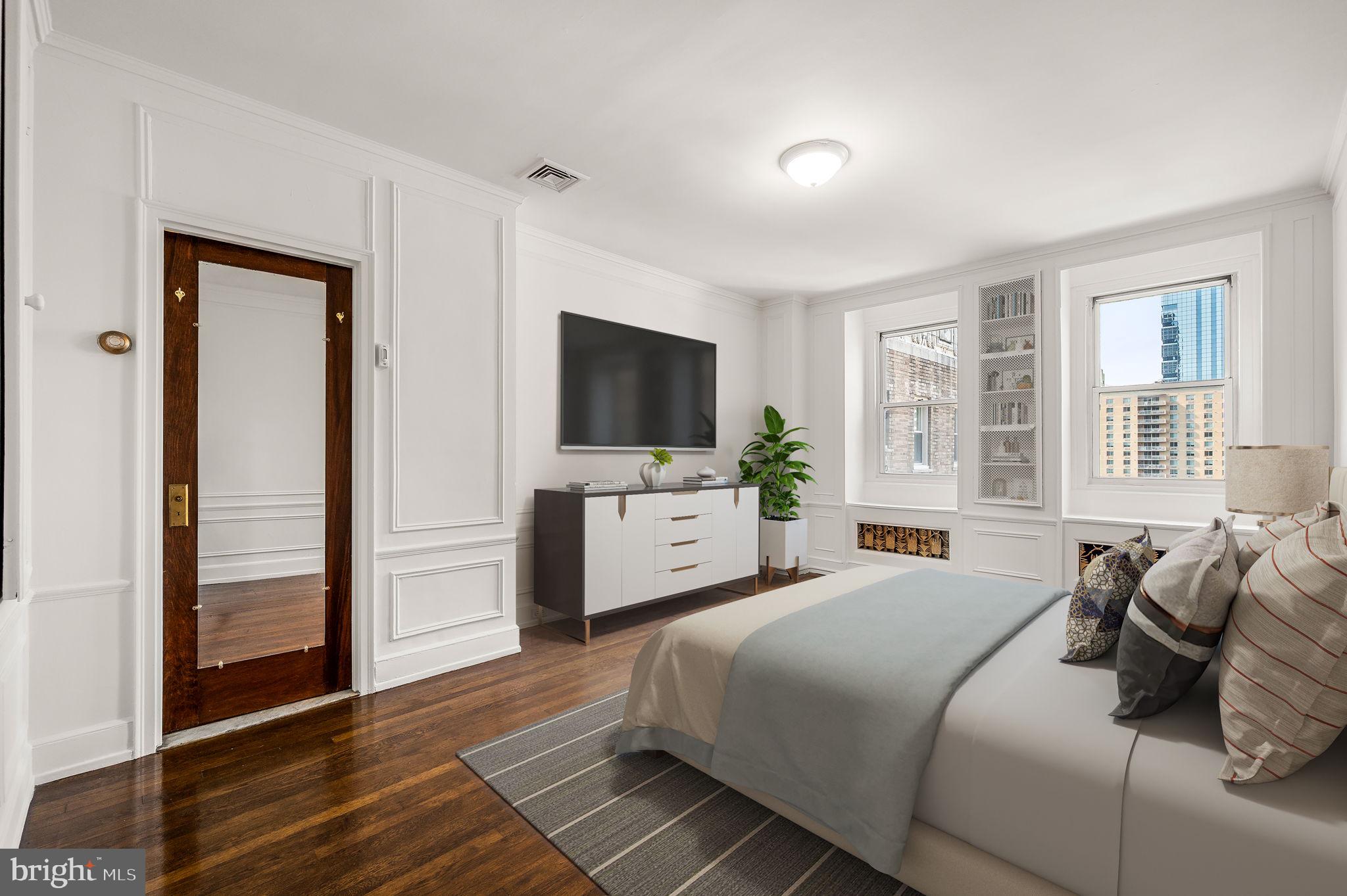 1901 Walnut Street, Unit 20B Philadelphia, PA 19103 - Photo 4 of 24 a bedroom with a bed and a flat screen tv