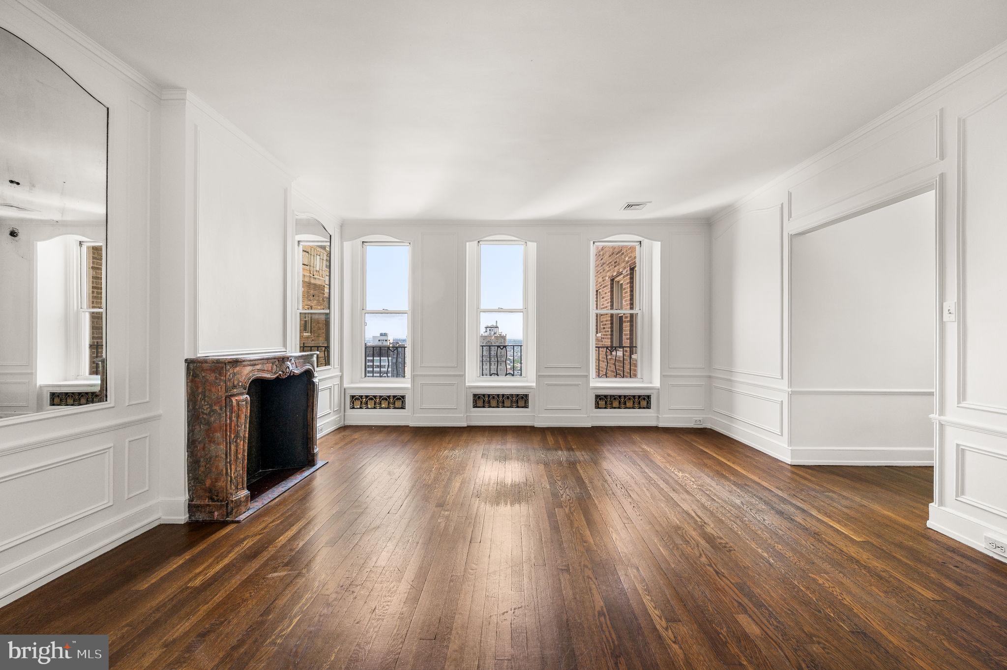 1901 Walnut Street, Unit 20B Philadelphia, PA 19103 - Photo 6 of 24 an empty room with wooden floor and windows