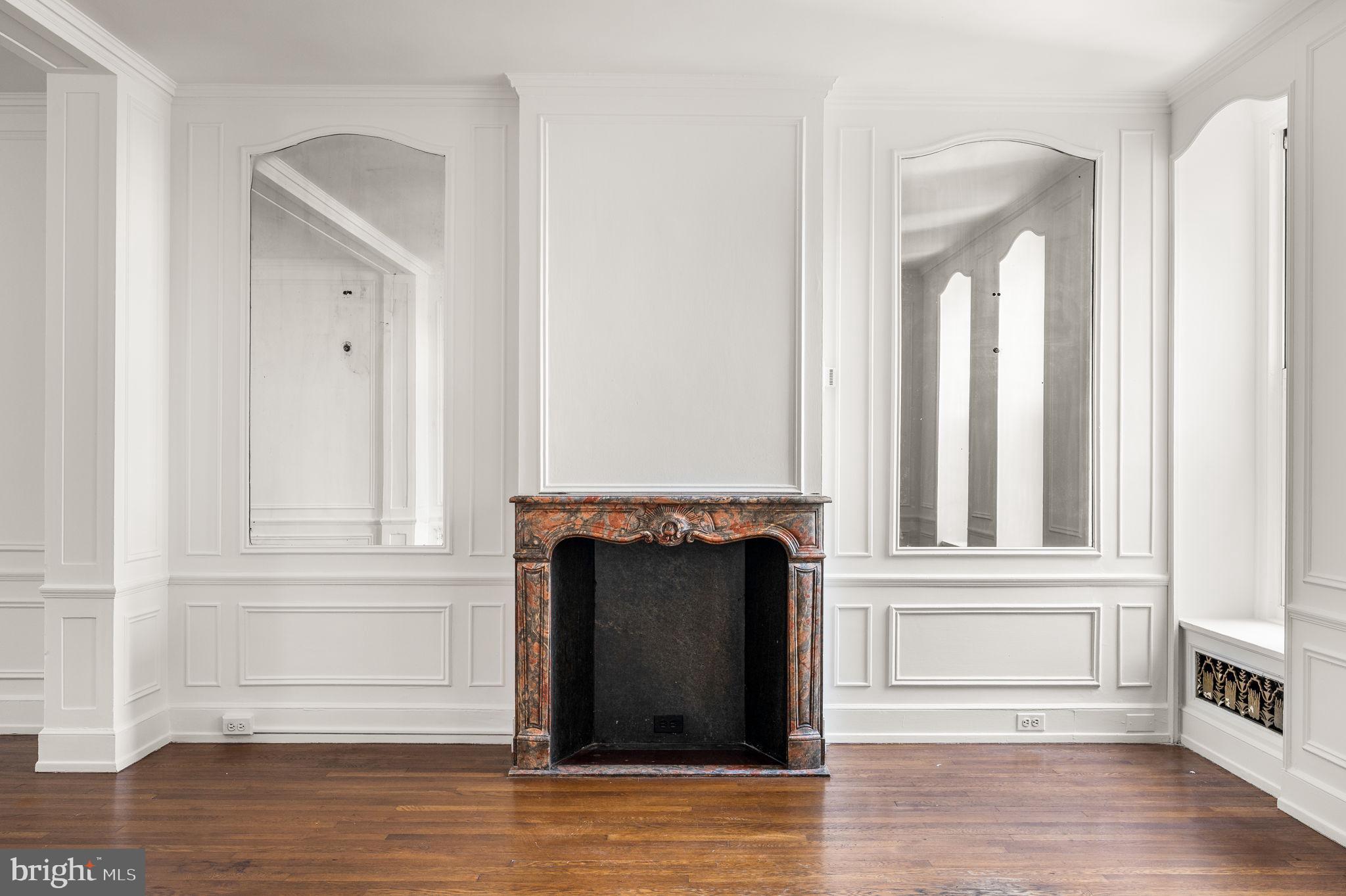 1901 Walnut Street, Unit 20B Philadelphia, PA 19103 - Photo 8 of 24 a view of a livingroom with wooden floor and fireplace