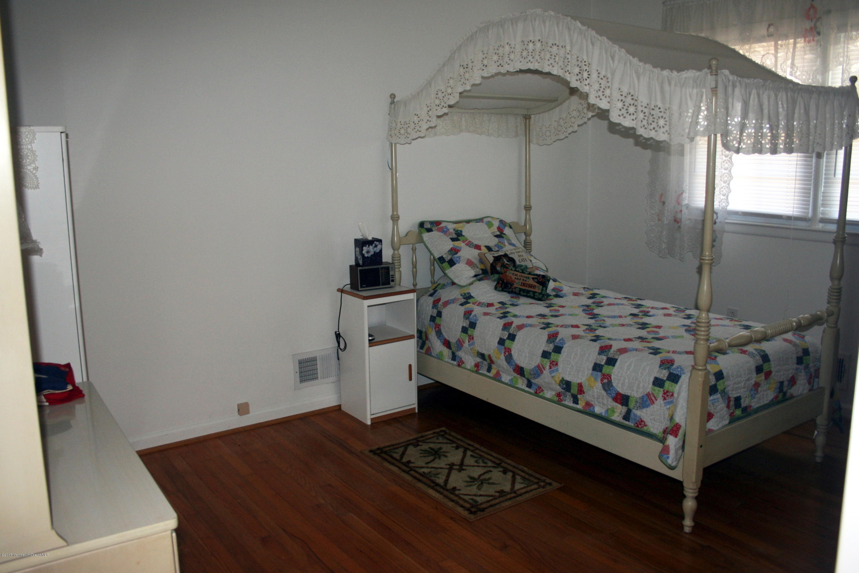 867 Monmouth Road Cream Ridge, NJ 08514 - Photo 13 of 19 a bed sitting in a bedroom next to a window
