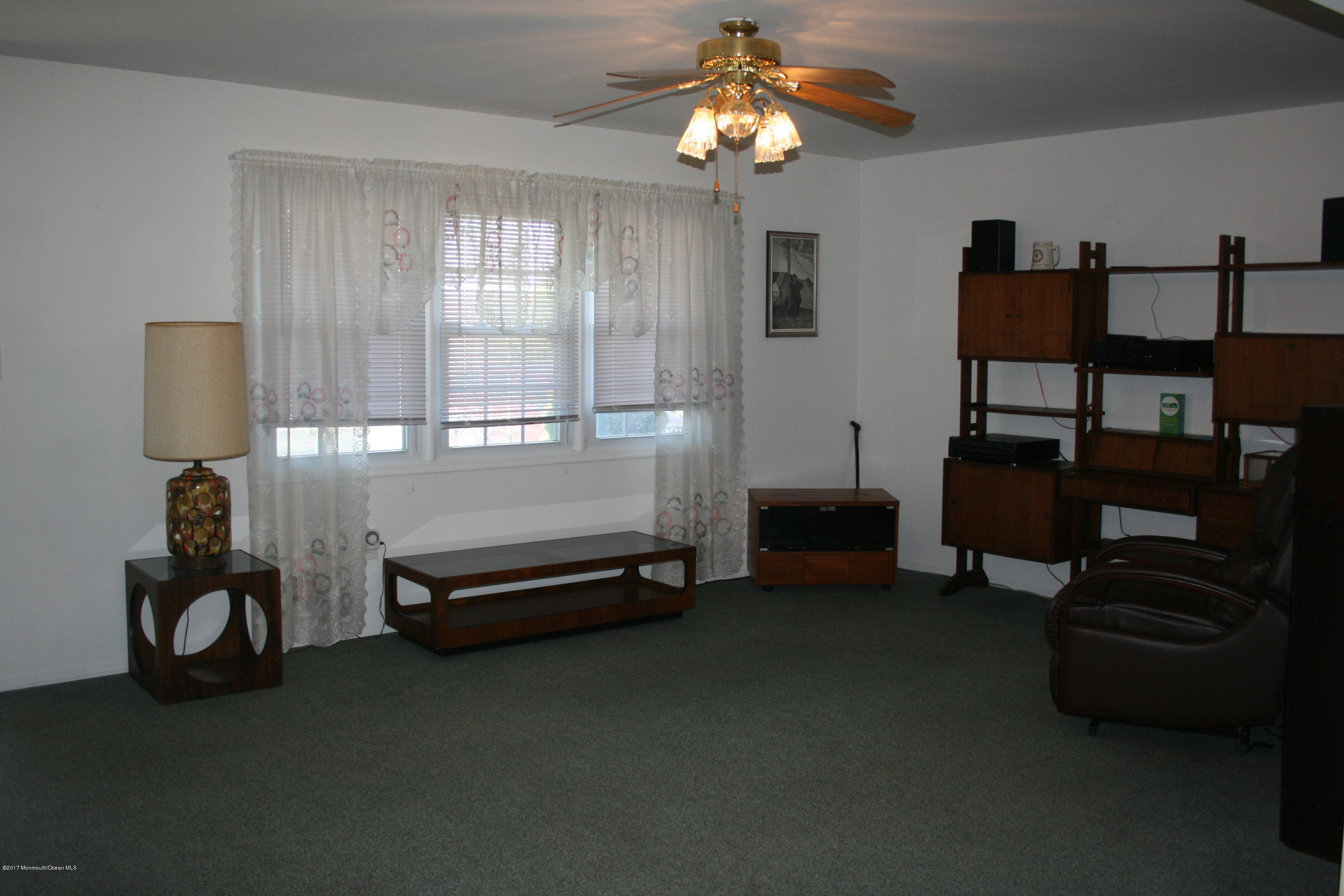 867 Monmouth Road Cream Ridge, NJ 08514 - Photo 4 of 19 a living room with furniture gym equipment and a window