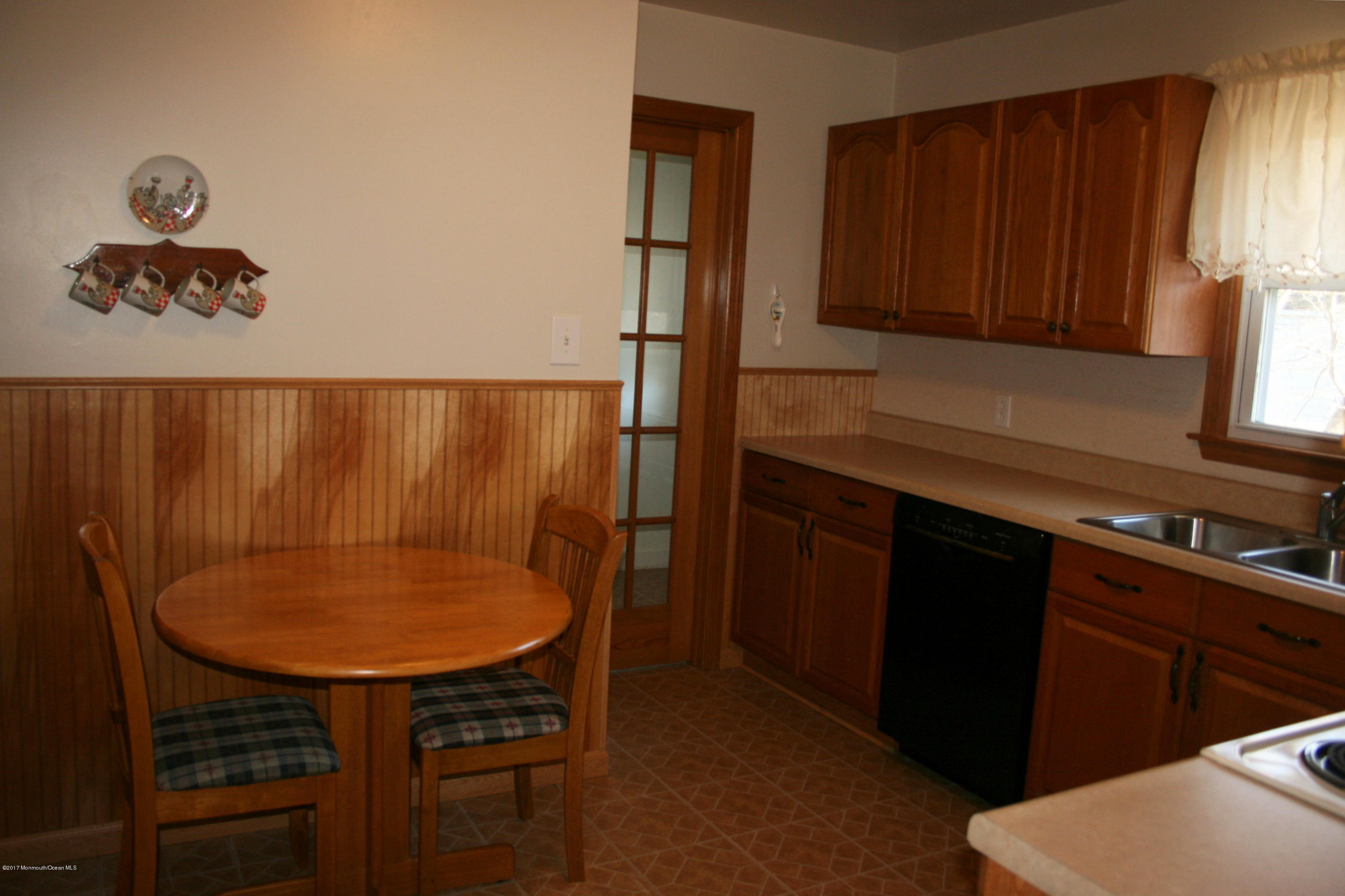 867 Monmouth Road Cream Ridge, NJ 08514 - Photo 6 of 19 a kitchen with a table chairs sink and cabinets