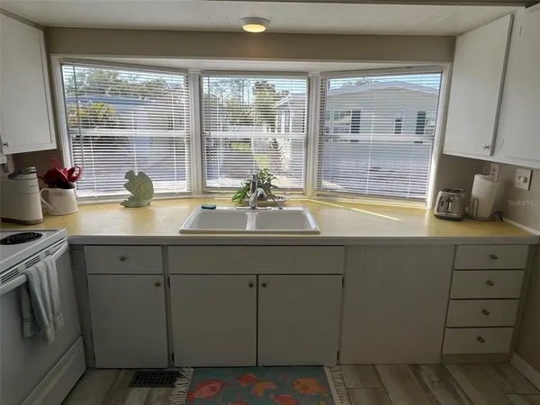 a kitchen with a sink and wooden cabinets