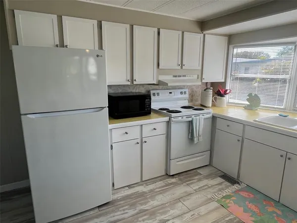 a kitchen with appliances cabinets and a sink