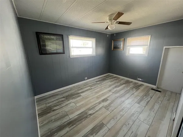 a view of room with window and ceiling fan