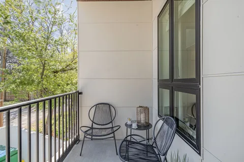 a room with wooden floor pool table and windows