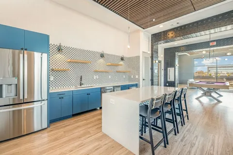 a dining room with wooden floor a glass table and chairs