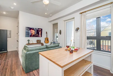 a kitchen with kitchen island a white counter top space cabinets and stainless steel appliances
