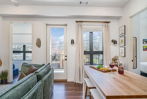 a kitchen with kitchen island white cabinets stainless steel appliances and wooden floor
