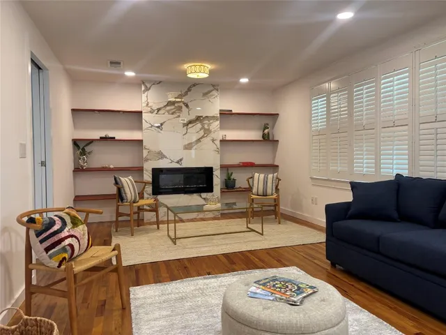 a kitchen with stainless steel appliances kitchen island granite countertop a refrigerator a stove and a sink