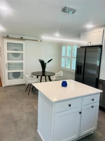 a kitchen with a stove a sink and a refrigerator