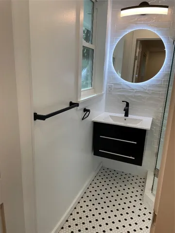 a bathroom with a sink and shower