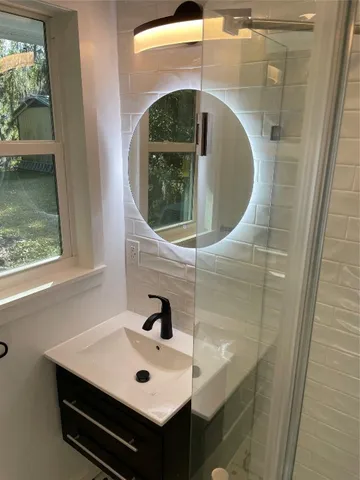 a bathroom with a toilet and a mirror