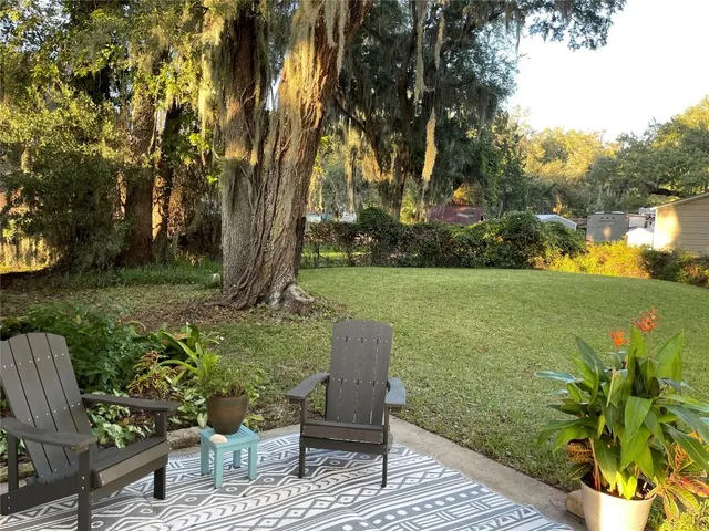 a view of a porch with furniture and garden