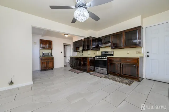 a bathroom with a granite countertop toilet sink and mirror