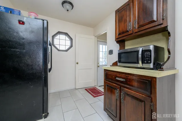 a view of a hallway with wooden floor and stairs