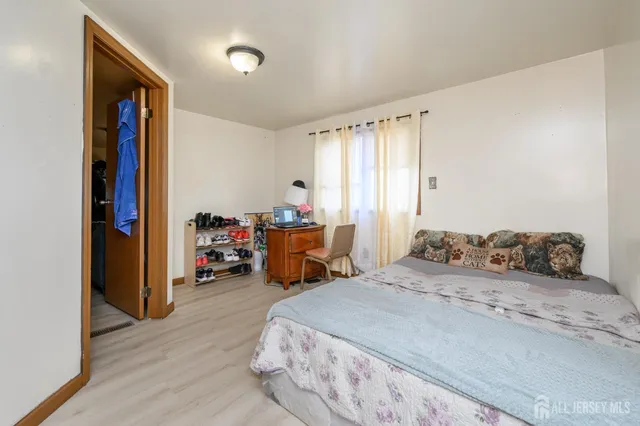 a bed room with a bed and a chair