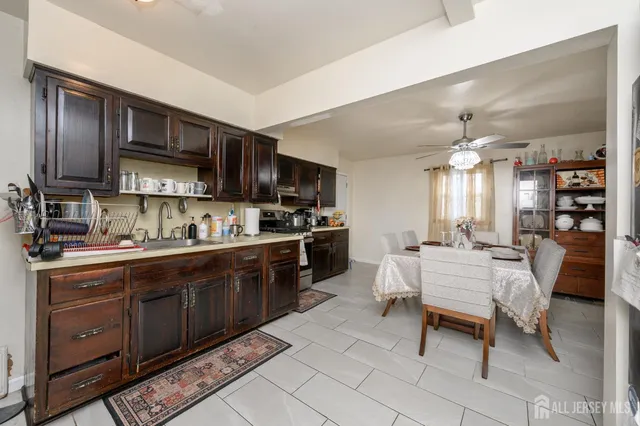 a open kitchen with stainless steel appliances granite countertop a stove top oven a sink dishwasher and cabinets