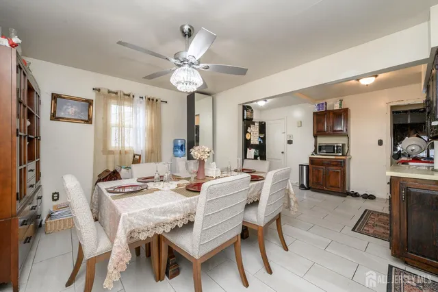 a view of a dining room with furniture and a chandelier