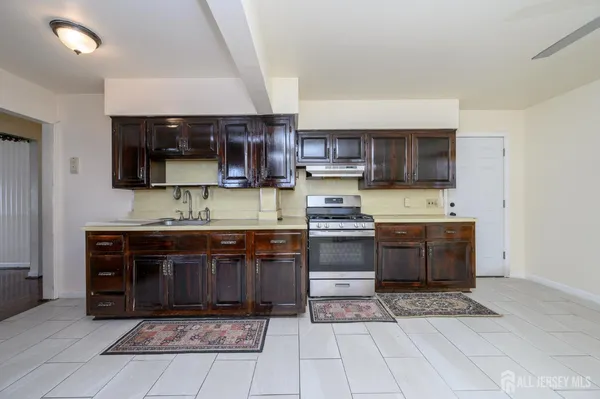 a kitchen with stainless steel appliances granite countertop a stove a microwave and cabinets